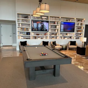 a pool table in the lounge area
