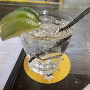 a drink with a lime wedge