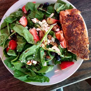 Spinach with berries,candied pecans, cheese &amp; balsamic dressing. Add the grilled salmon.  Easily a $20 salad. @theloon, it was under $12.