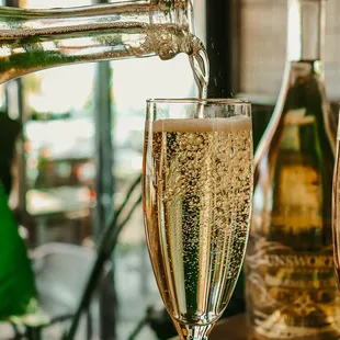 a glass of champagne being poured