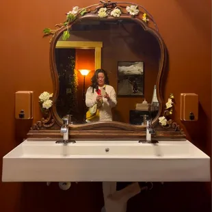a woman taking a selfie in a mirror