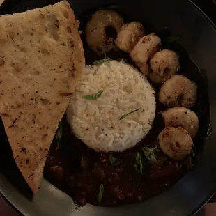 Shrimp and sweet &amp; spicy stewed tomatoes over rice.