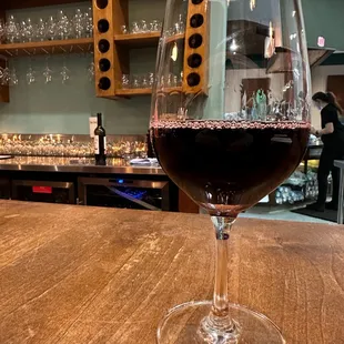 a glass of wine on a bar
