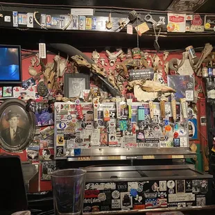 a bar with a lot of items on the wall