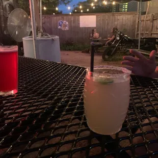 a person sitting at a table with a drink