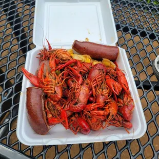 a tray of crawfish and hot dogs