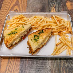 a grilled sandwich and french fries