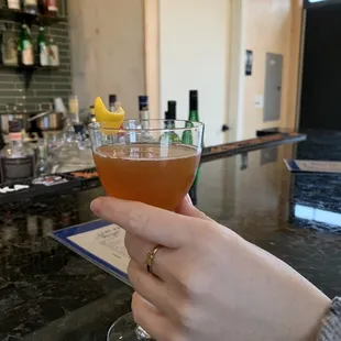 a person holding a glass of alcohol