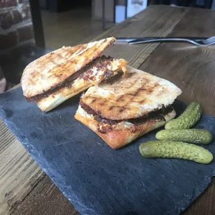 a grilled sandwich and pickles