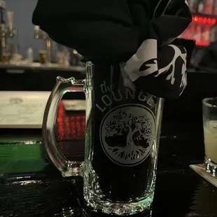 a glass of beer and a napkin