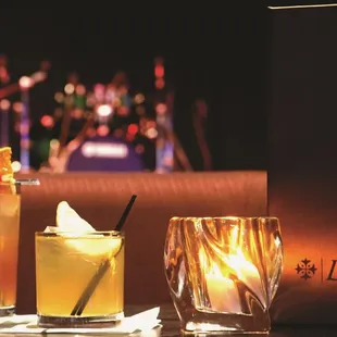 two cocktails and a candle