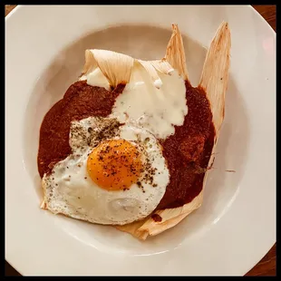 Homemade baked tamale on Oaxacan-style mole