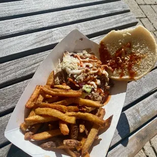 a sandwich and fries on a picnic table