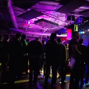 a group of people standing in a dark room