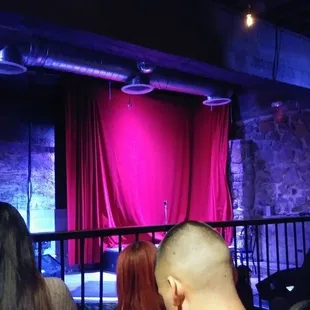 a stage with a red curtain