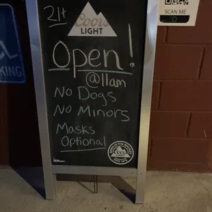 a chalk board with a sign stating it is open