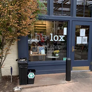 a storefront with a sign on the door