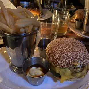 The Loyalist Original Cheeseburger - pickled &amp; charred onion, sesame seed bun, frites, aioli ($22 as of June 2023)