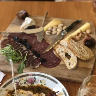 a plate of meat, cheese, and bread