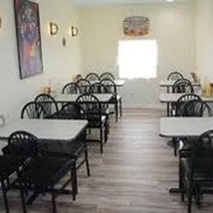 a dining room with tables and chairs