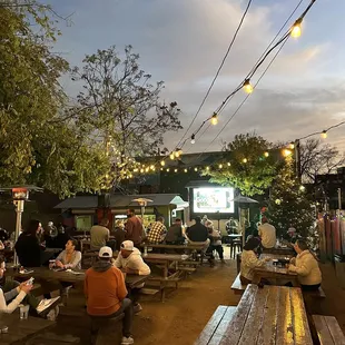 a group of people sitting at picnic tables