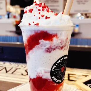 a cup of ice cream and strawberries
