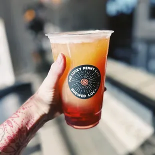 a hand holding a drink