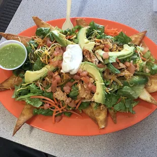 a plate of nachos with avocado