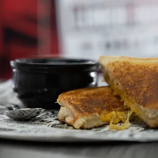 a grilled cheese sandwich and a cup of coffee