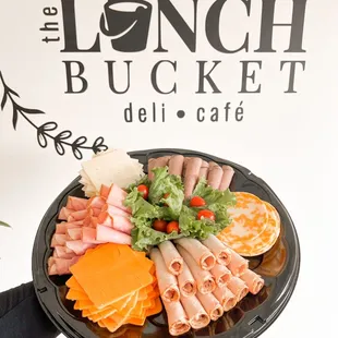 a person holding a platter of food