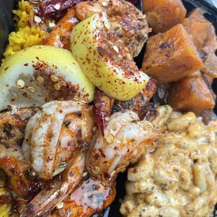 The glazed salmon with shrimp topped over yellow rice, and my two sides were the yams and Mac &amp; Cheese.