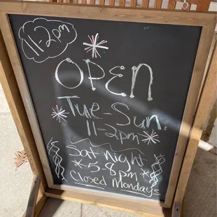 a chalk board with the words open
