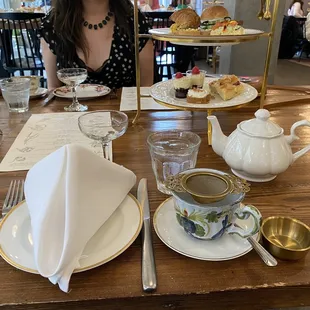 a woman sitting at a table in a restaurant