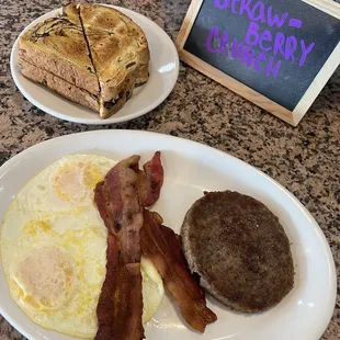 a breakfast of eggs, bacon and toast