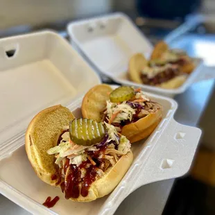 two sandwiches in a styrofoam container