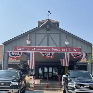 two trucks parked in front of it