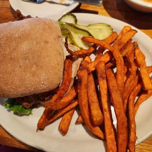 breaded chicken sandwich with sweet potato fries.