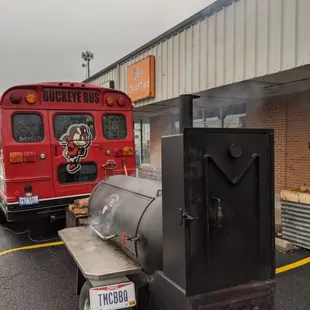 a red bus and a black grill