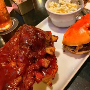 a plate of ribs and a bowl of macaroni and cheese