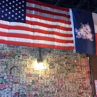 an american flag hanging on a brick wall