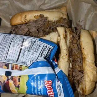 Philly Cheesesteak - Thinly sliced steak grilled with onions and topped with melted white American cheese on hoagie bread