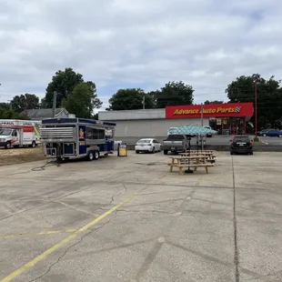 a parking lot with trucks and tables