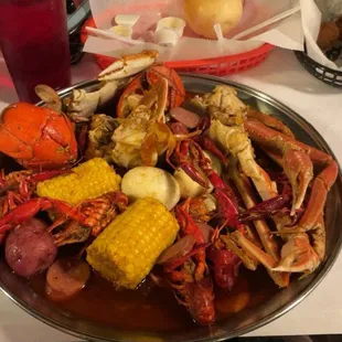 a plate of crab legs and corn on the cob