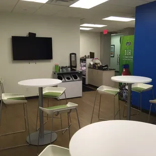 a view of a cafeteria with tables and chairs