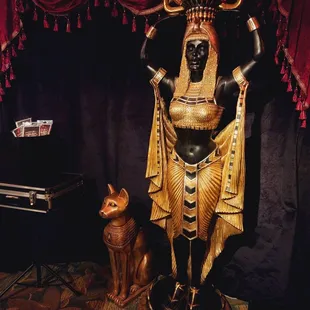 an egyptian statue and a cat