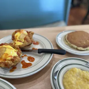 Eggs Bennie with pancakes. Egg whites with onion, spinach, mushroom and feta cheese, grits and avocado toast. YUM!!!