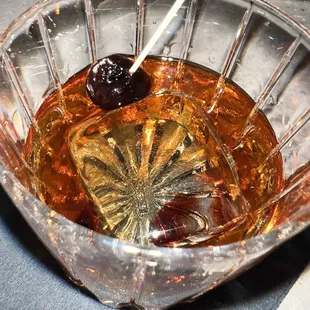 a glass bowl of liquid with a spoon in it