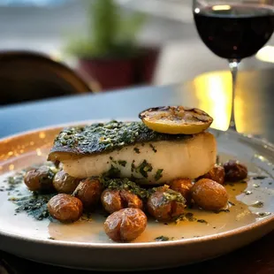 a plate of food and a glass of wine