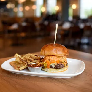 a burger and chips on a plate