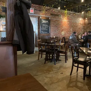 people sitting at tables in a restaurant